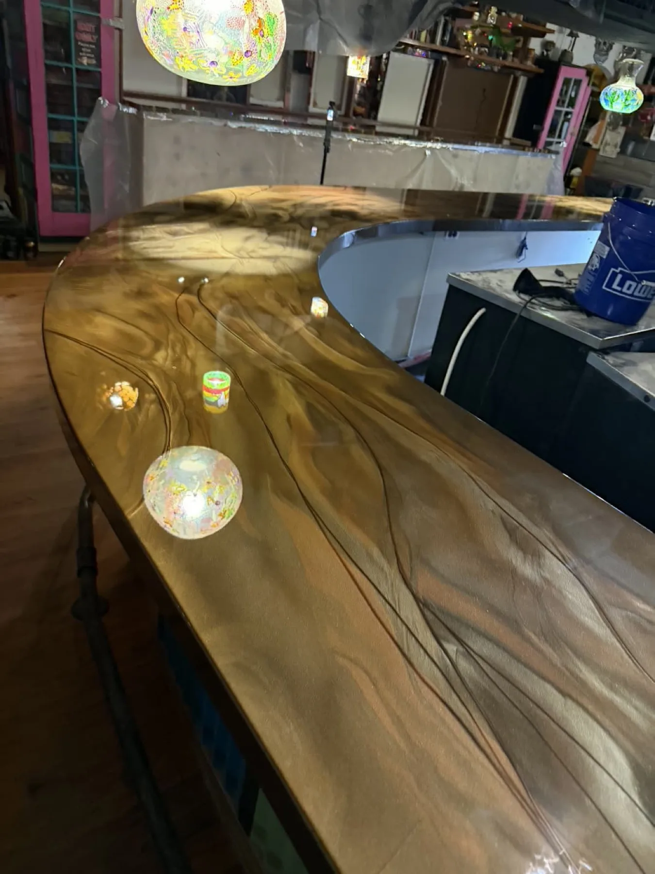 Curved gold metallic epoxy bar top in a Wayne County, North Carolina home
