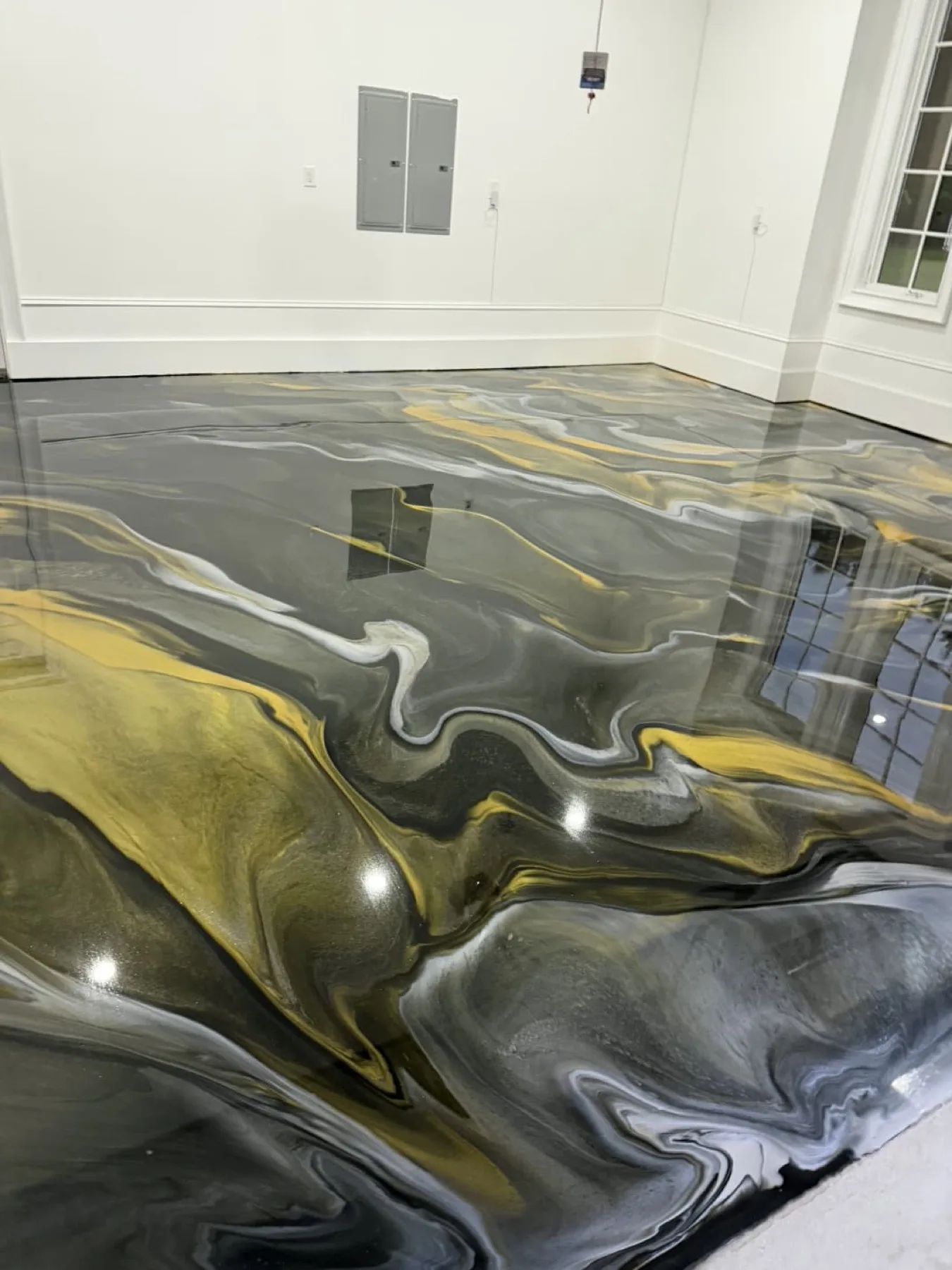 Gold and gray metallic epoxy floor in a Wayne County, North Carolina garage