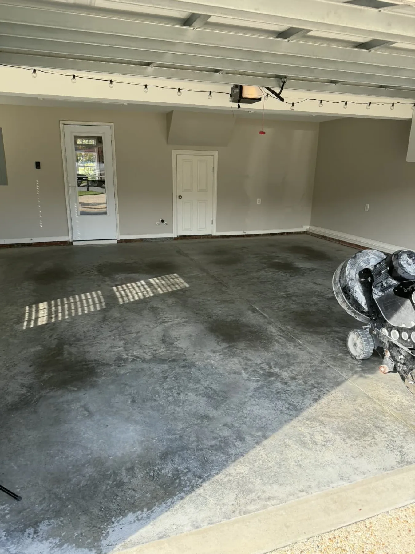 Oil stained garage slab before epoxy coating in Wayne County, North Carolina
